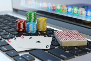 piles de jetons et des cartes dont un carre d'as poses sur un clavier